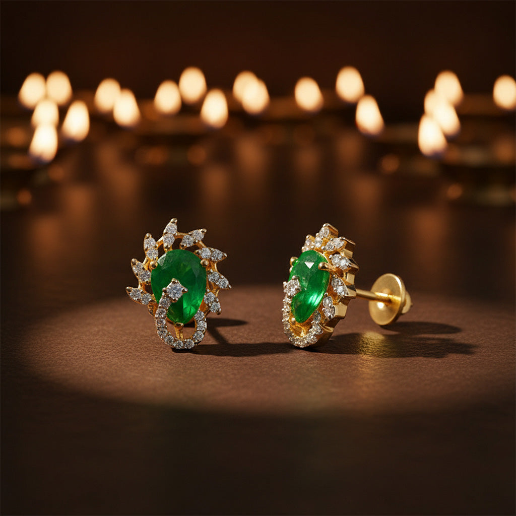 Gold earrings with green gemstones on a dark background