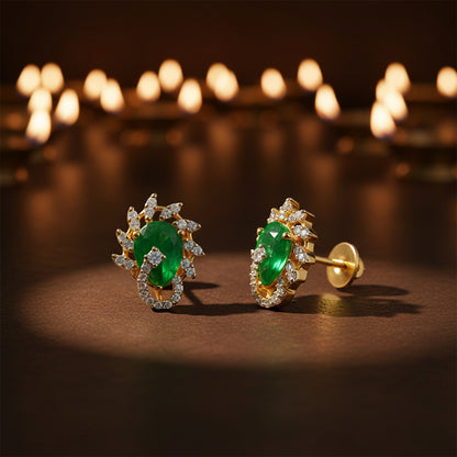 Gold earrings with green gemstones on a dark background