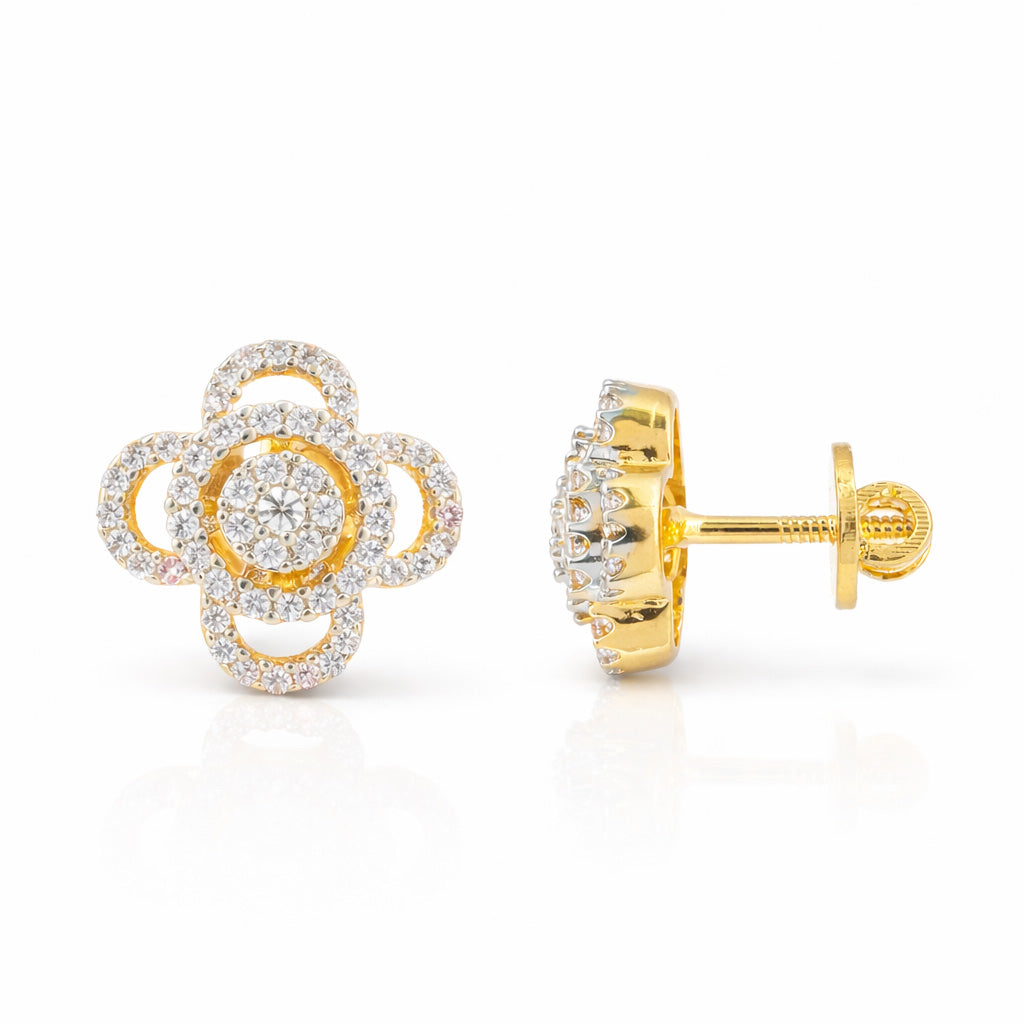 Gold and diamond flower-shaped earrings on a white background
