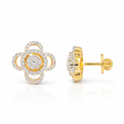 Gold and diamond flower-shaped earrings on a white background