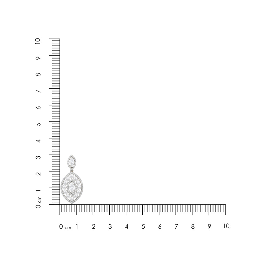 Silver pendant with a clear gemstone next to a ruler on a white background