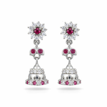 Silver earrings with red gemstones on a white background