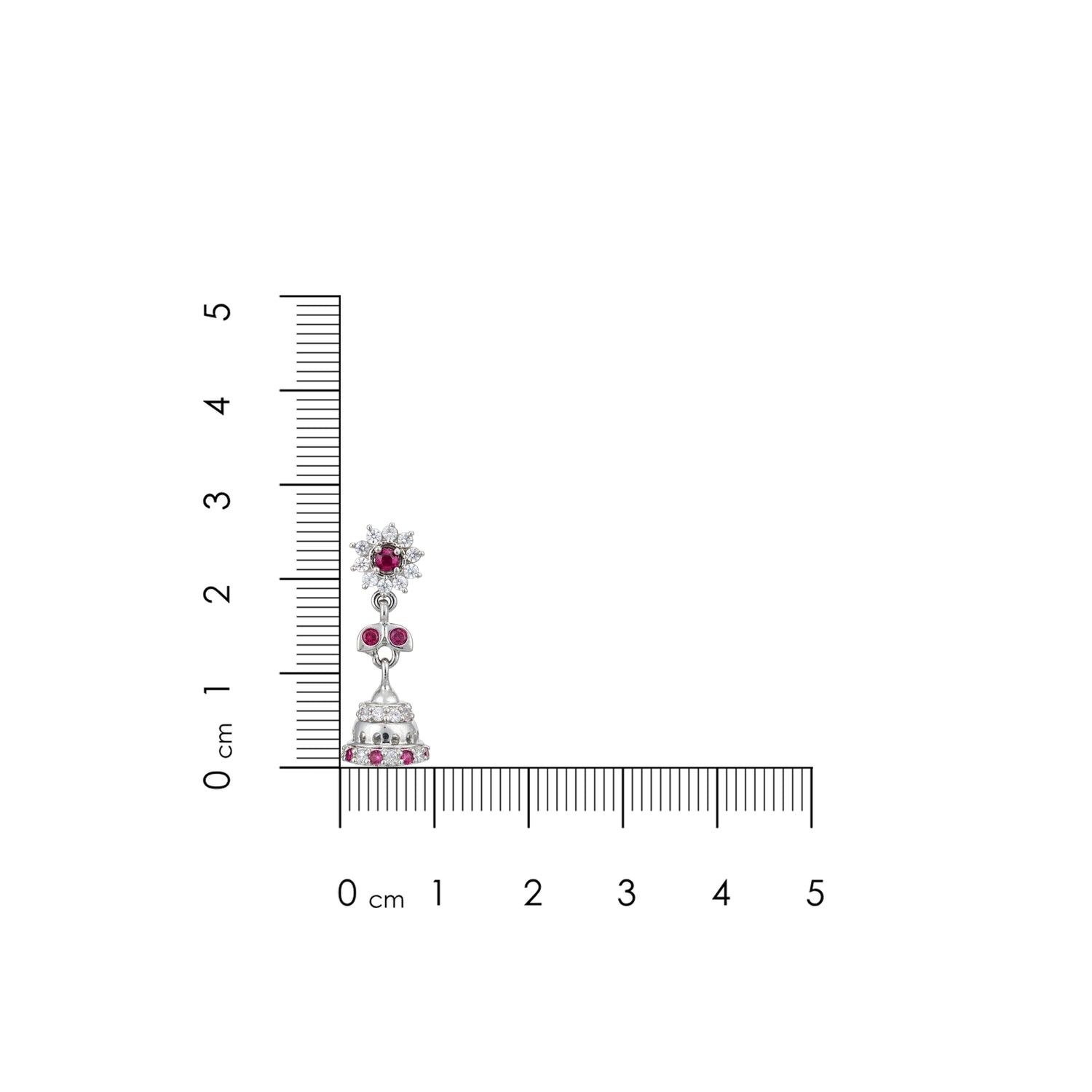Jewelry earring with embedded gemstones next to a ruler for scale on a white background