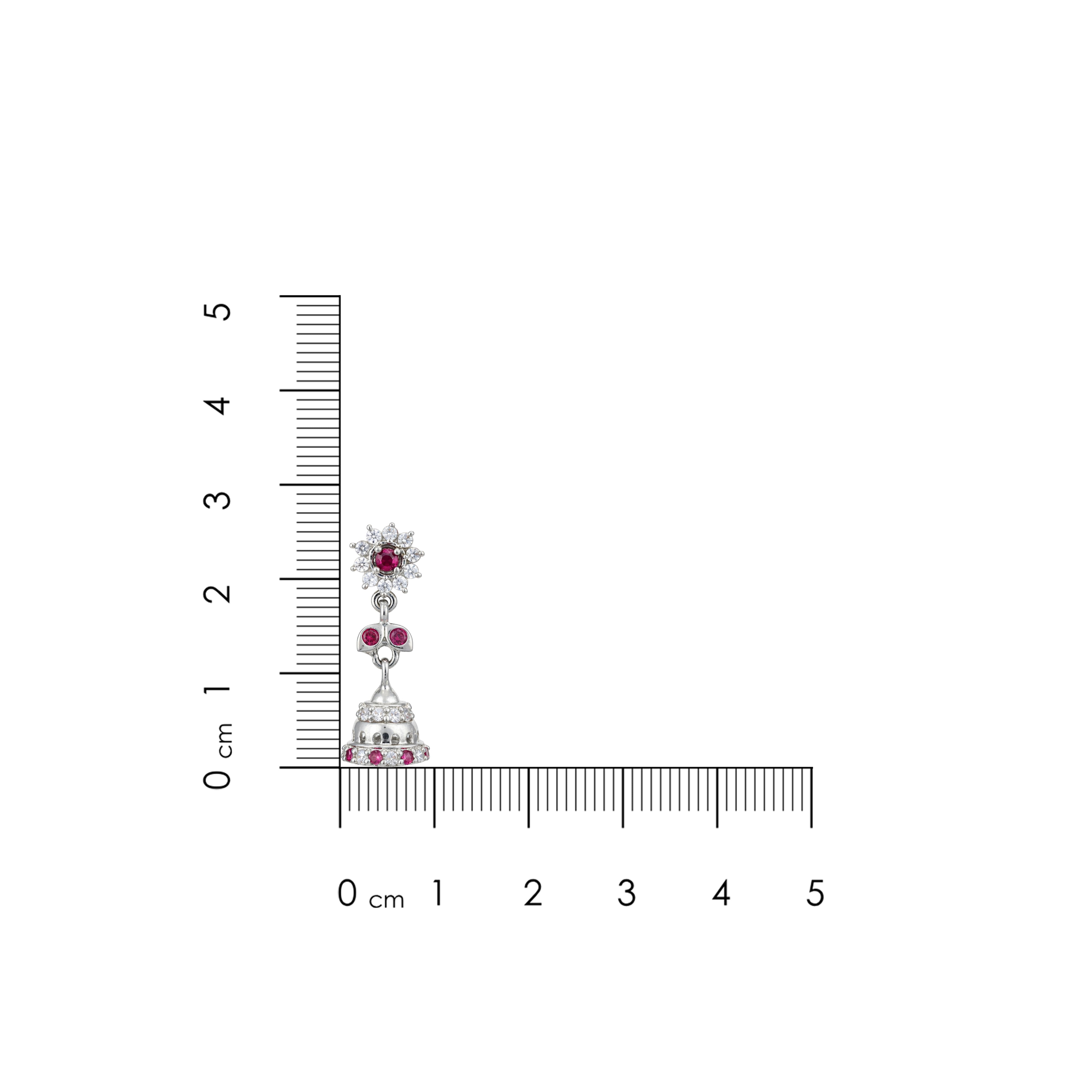 Jewelry earring with embedded gemstones next to a ruler for scale on a white background