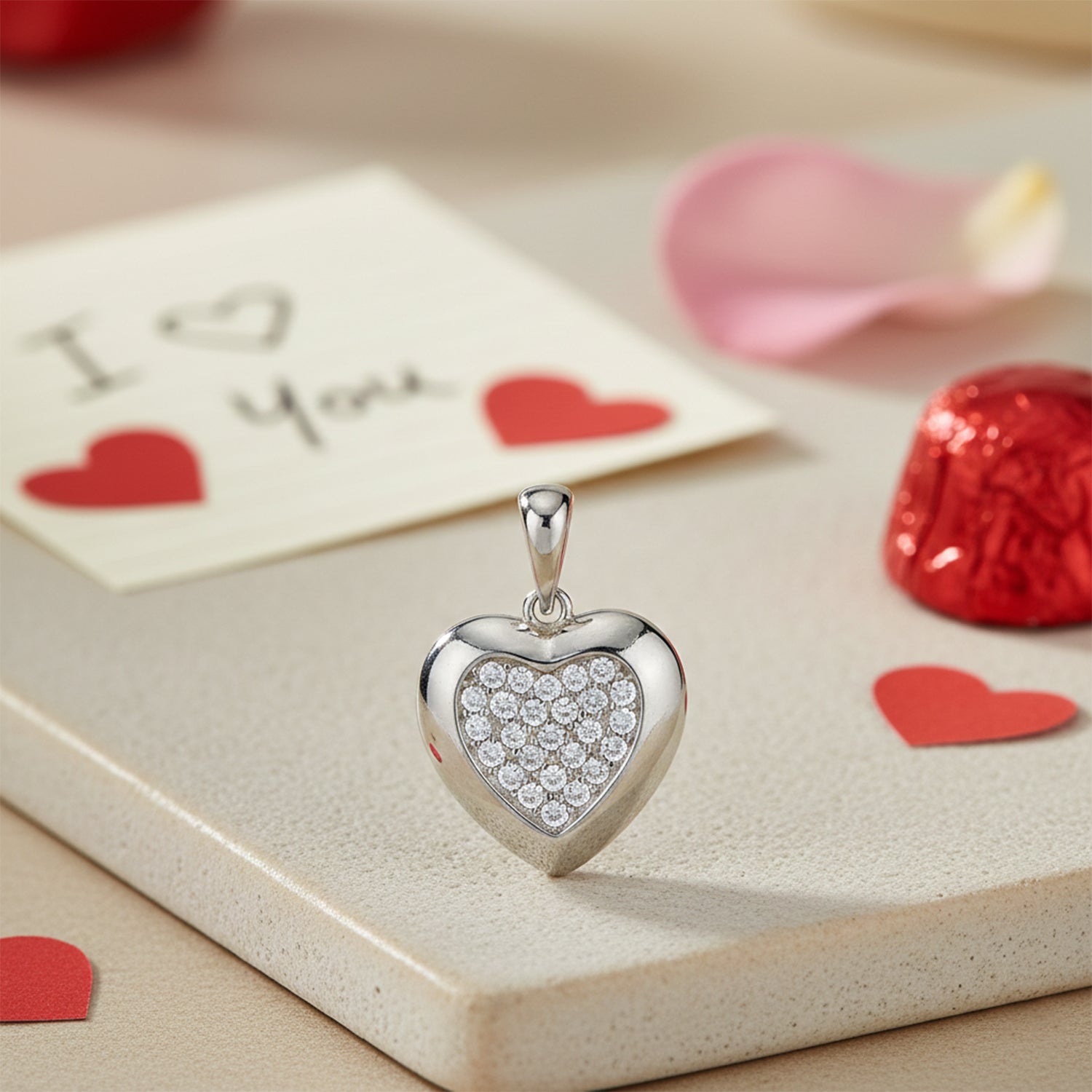 Heart-shaped silver pendant with clear stones on a romantic setting with &