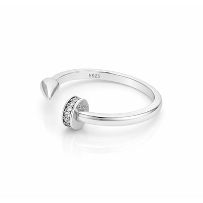 Silver ring with a small circular design on a white background