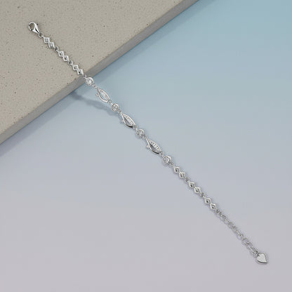Silver bracelet on a light blue surface