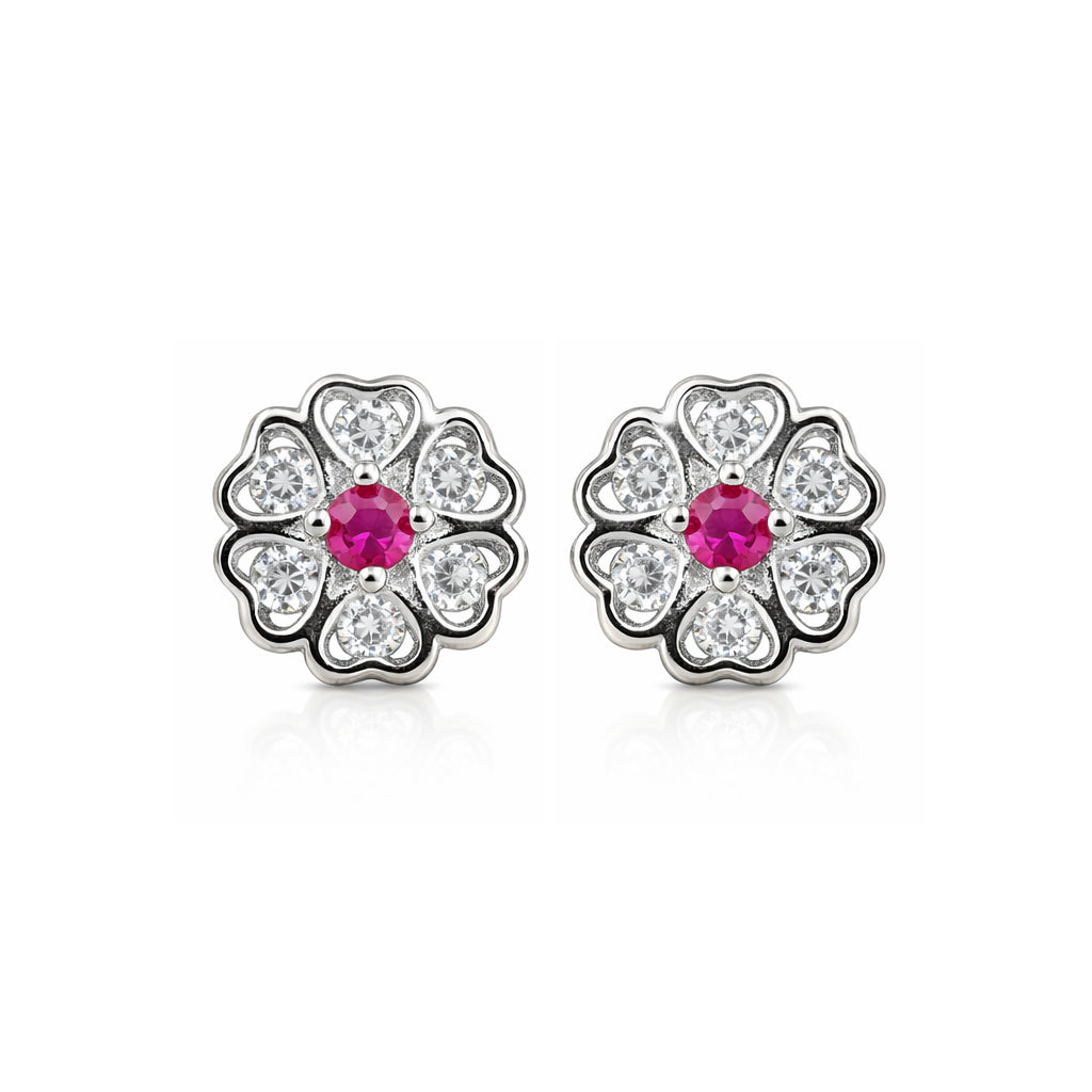 Pair of silver flower-shaped earrings with pink gemstones on a white background