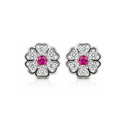 Pair of silver flower-shaped earrings with pink gemstones on a white background