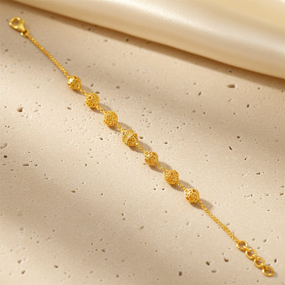 Gold bracelet on a beige fabric background