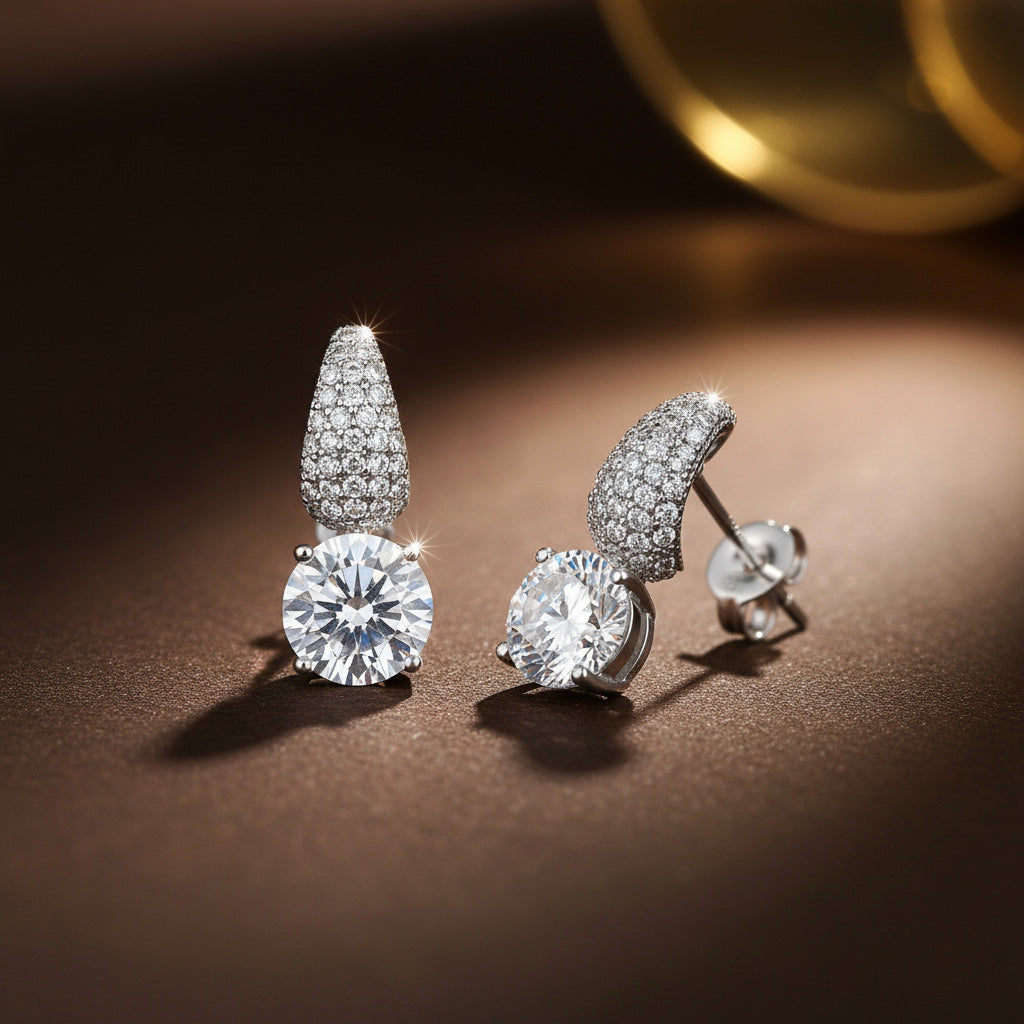 Pair of diamond earrings on a brown surface