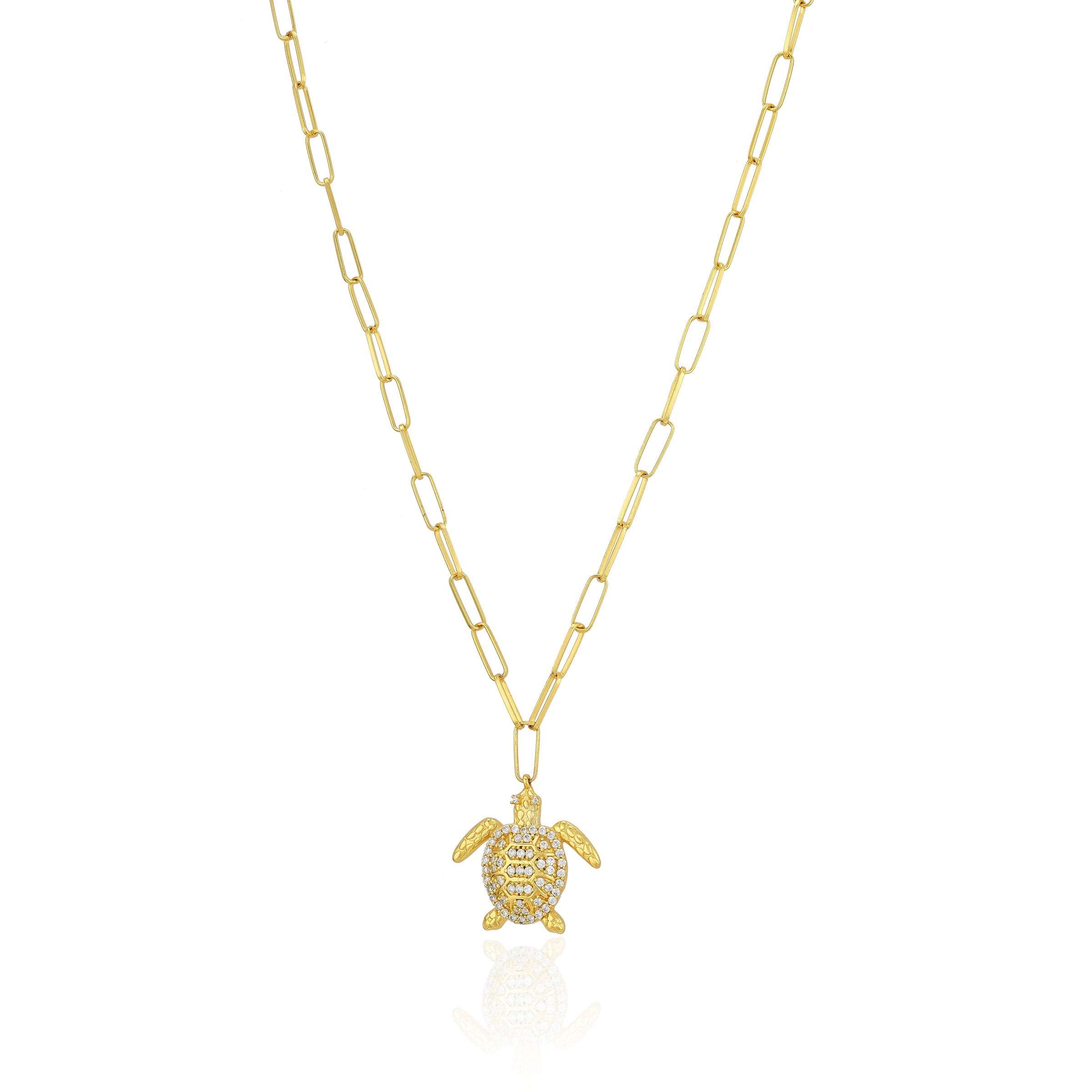 Gold turtle pendant necklace on a white background