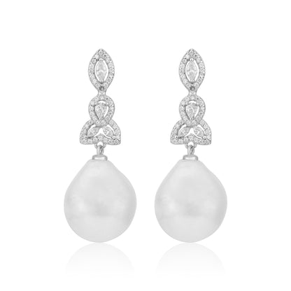 Pair of earrings with teardrop-shaped pearls and diamond-like stones on a white background